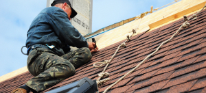 man installing roof shingles Florence SC